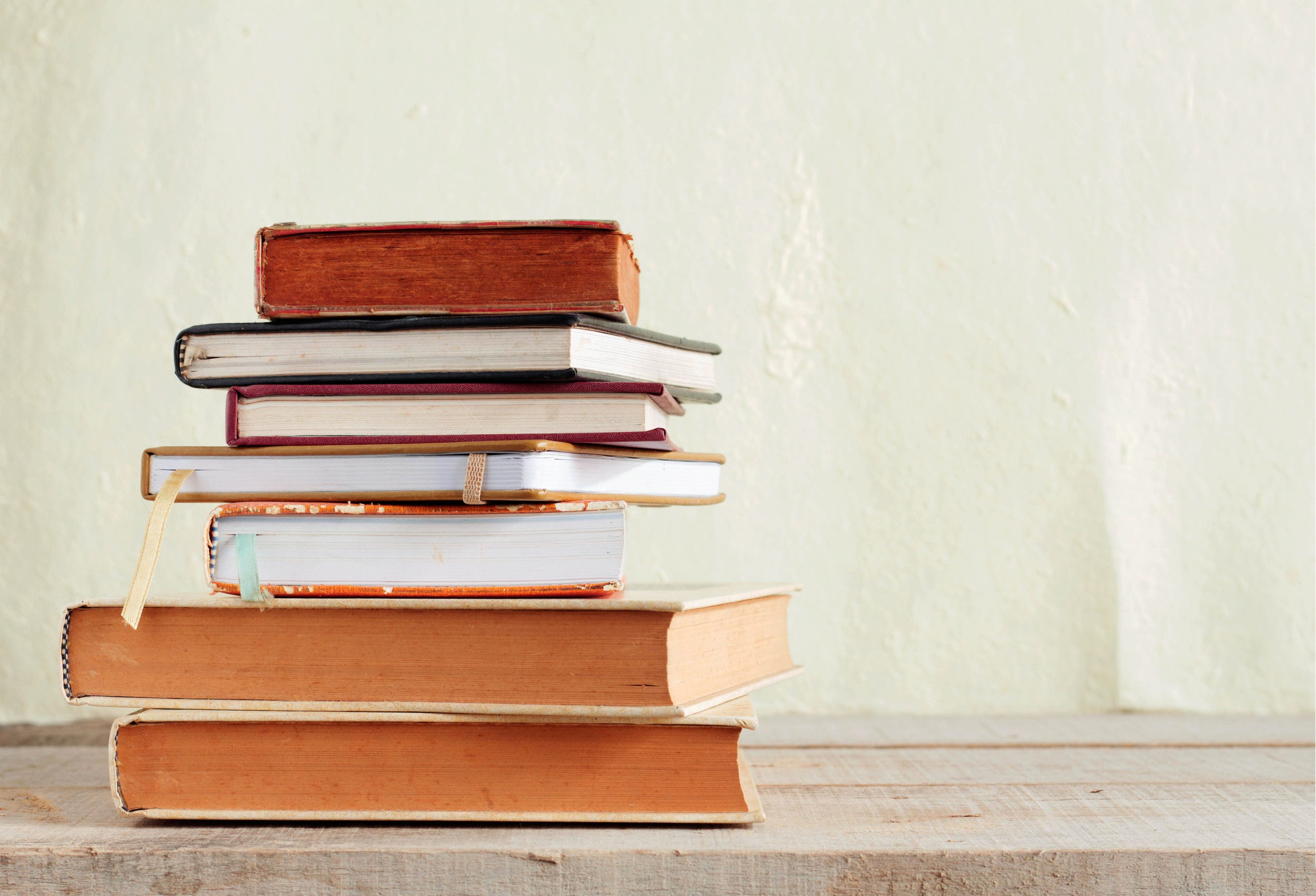 Old books of stacked on wooden floor.